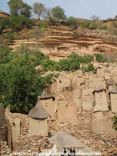 Dogon village with Tellem cliff dwellings above Dogon village with Tellem cliff dwellings above