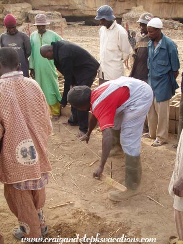 Oumar Degoga, the mason, marks the perimeter of the new water basin