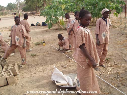 Kids measure out where to plant the trees Kids measure out where to plant the trees