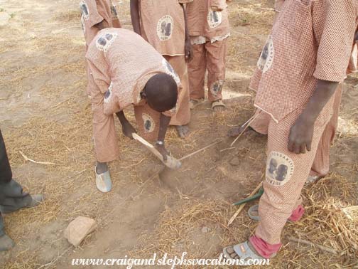 Kids dig holes for planting trees Kids dig holes for planting trees