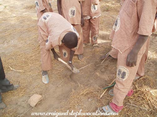 Kids dig holes for planting trees