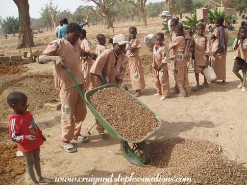 Kids deliver rocks for the concrete