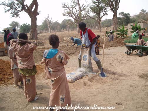Oumar Degoga prepares the concrete for the water basin Oumar Degoga prepares the concrete for the water basin