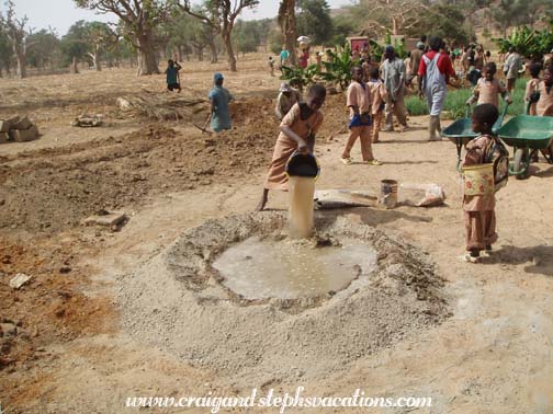 Kids add water to the concrete mix Kids add water to the concrete mix