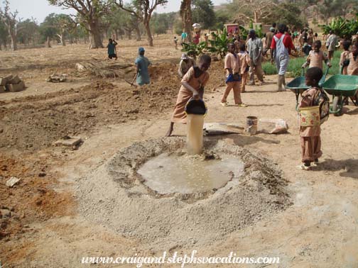 Kids add water to the concrete mix