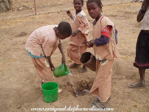 Kids water the tree holes Kids water the tree holes