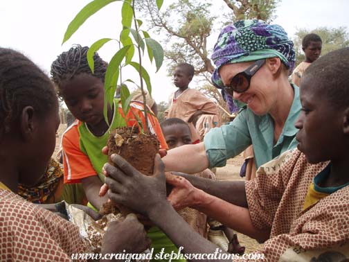 Susan plants a tree with the students Susan plants a tree with the students