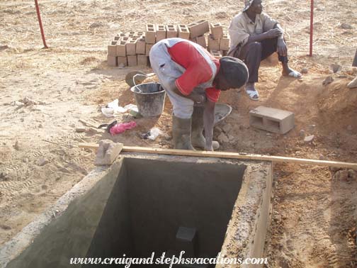Mason Oumar Degoga puts finishing touches on the water basin Mason Oumar Degoga puts finishing touches on the water basin