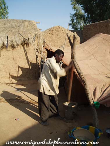 Bozo man demonstrates pounding millet Bozo man demonstrates pounding millet