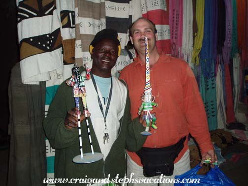 Shopkeeper selling metal sculptures