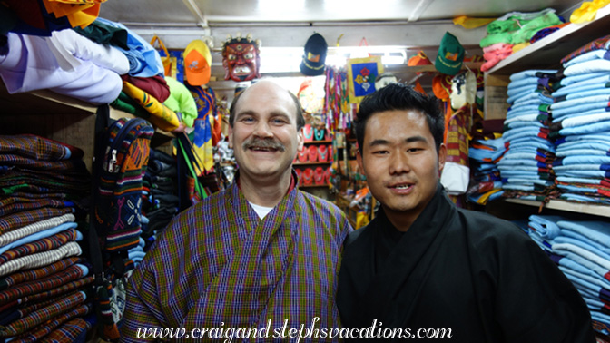 Sonam Tshering helps his dad shop for a gho