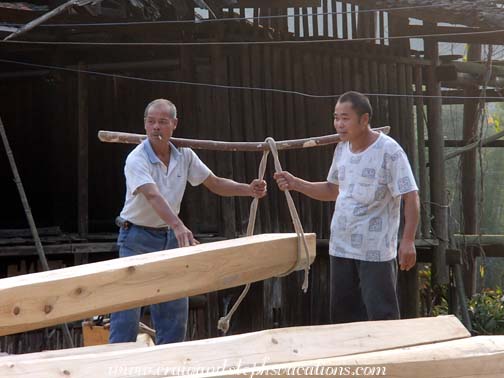 Carpenters transporting logs for the new drum tower