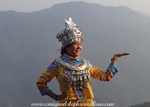 Our new friend gets photographed in traditional Miao clothing