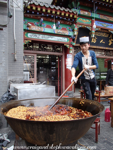 Bubbling vat of spices and peppers, cooking on the sidewalk in the Muslim Quarter