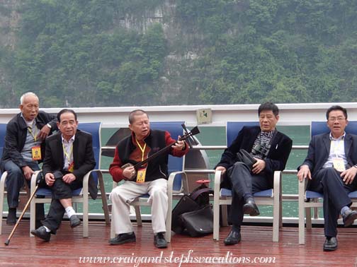 Chinese passengers provide musical entertainment on the observation deck