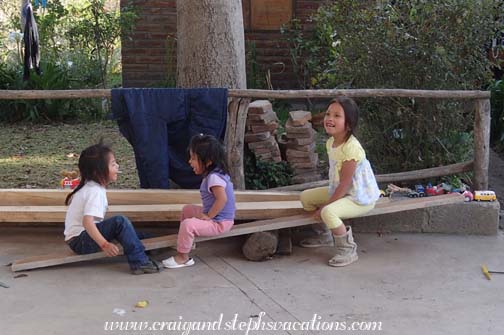 Yupanqui, Tayanta, and Sisa play on a makeshift see-saw