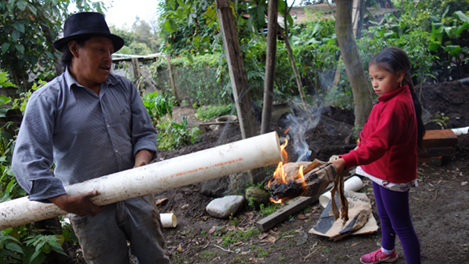 Sisa helps Antonio to heat the pipe to make a better seal