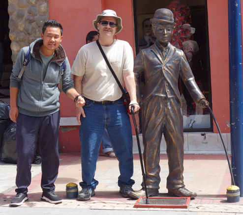 Posing with the Charlie Chaplin statue, Calle 10 de Agosto