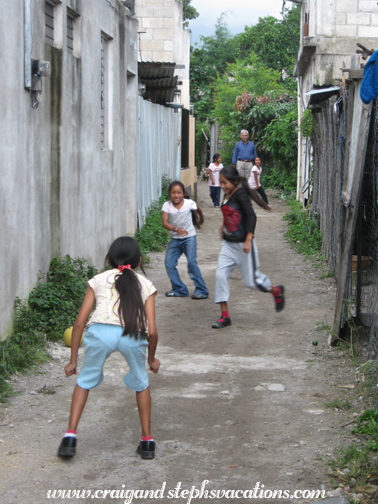 Girls playing ball in the alley