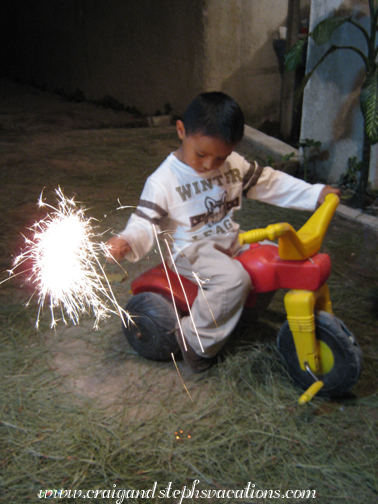Eddy rides his tricycle with a sparkler
