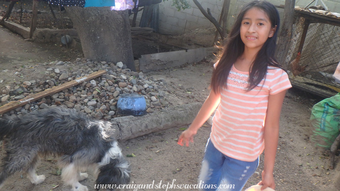 Aracely feeds Juana's dog some leftovers Aracely feeds Juana's dog some leftovers