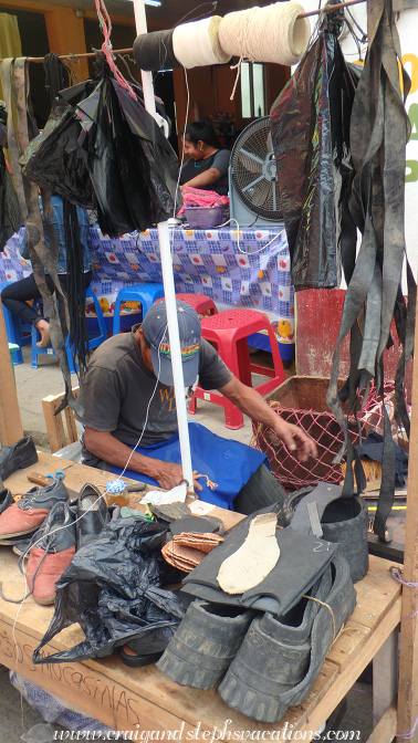 Cobbler repairing shoes with tire rubber