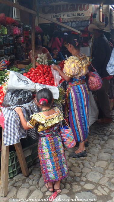 Mother and daughter buying tomatoes Mother and daughter buying tomatoes