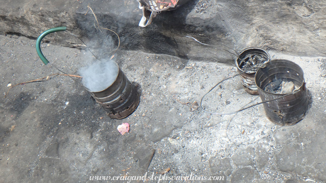 Incense smoldering in primitive censers made from cofee cans Incense smoldering in primitive censers made from cofee cans