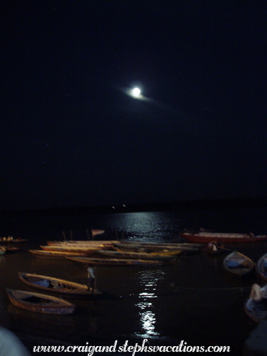 Full moon shines on boats on the Ganges