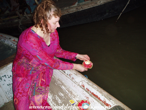 Lighting a candle and floating an offering into the Ganges
