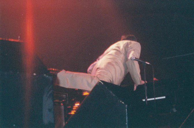 Jerry Lee Lewis kicks over his piano bench