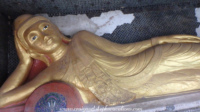 Gilded reclining Buddha in a cave at Phowin Taung