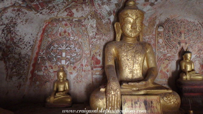 Gilded Buddhas and 18th century frescoes in a cave at Phowin Taung