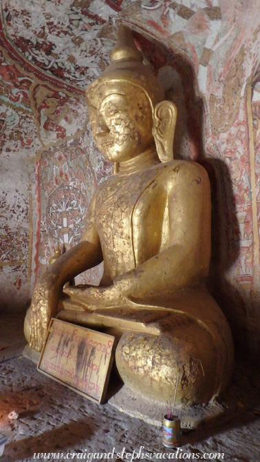 Gilded Buddha and 18th century frescoes in a cave at Phowin Taung