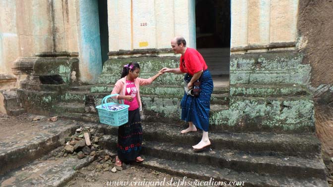 Young lady helps Craig down the steps from a cave, Phowin Taung