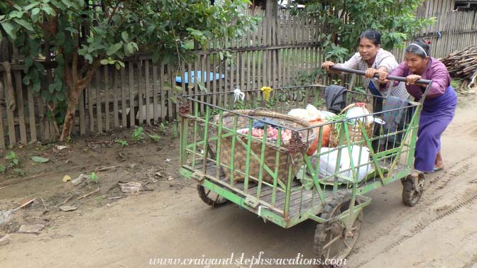 Women push a cart in Kanee Village