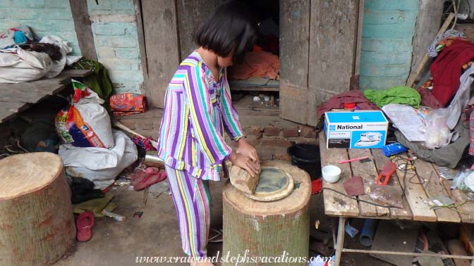 Girl grinding thanaka at Kanee market