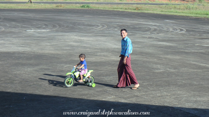Little boy rides his motorized bike on the tarmac Little boy rides his motorized bike on the tarmac