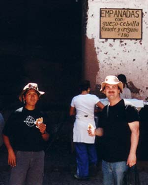 Vidal and Craig eating empanadas at the Pisac market