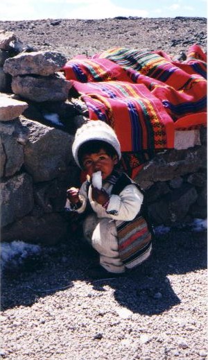 Peruvian toddler eating snow