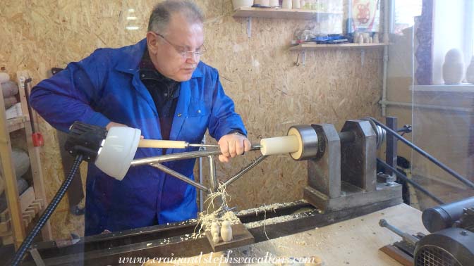 Vladim demonstrates how to shape a nesting doll on a lathe