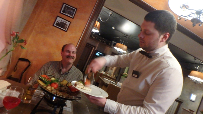 Our waiter serves us sadzh at Khinkalnaya on the Neva Georgian restaurant