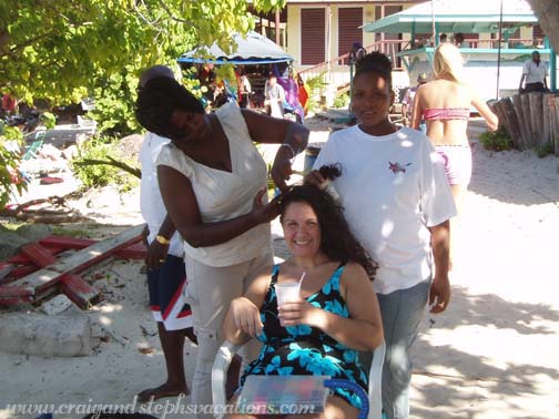 Gina getting her hair braided, Coki Point Beach