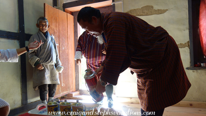 Caretaker Passa looks on while Apa serves us tea Caretaker Passa looks on while Apa serves us tea