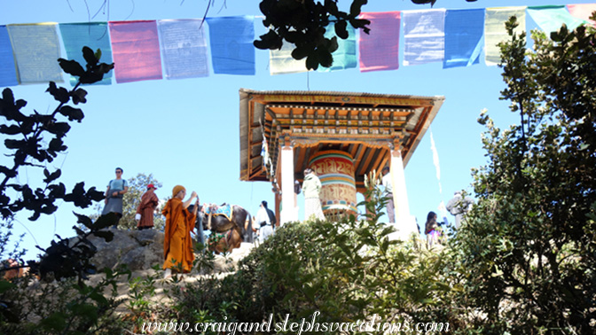 Pilgrims congregate at the prayer wheel