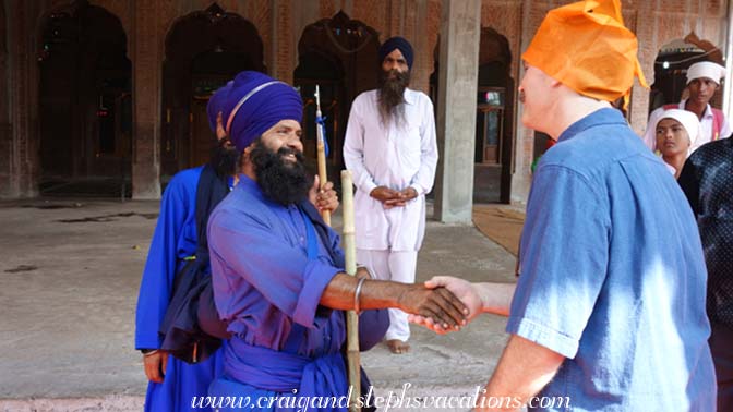 A uniformed Khalsa greets Craig