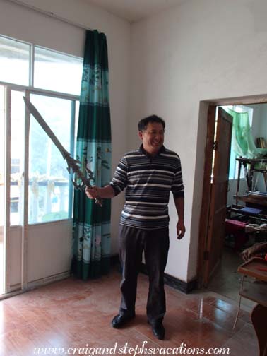 Mr. Zhou emerges with a sword