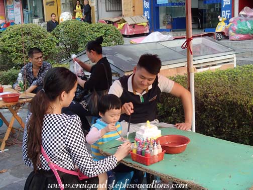 Painting plaster figurines in Kaili Square