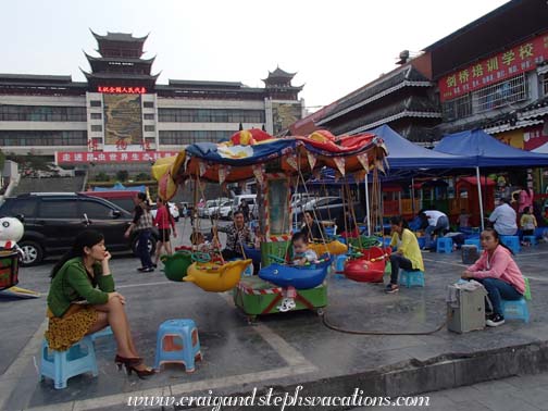 Kids on a merry-go-round in Kaili Square