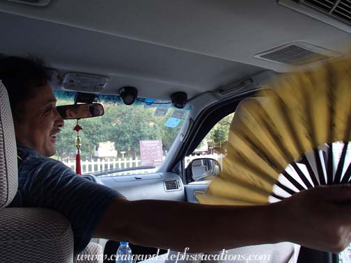 Mr. Zhou fans off an overheated Craig when we make it back to the car